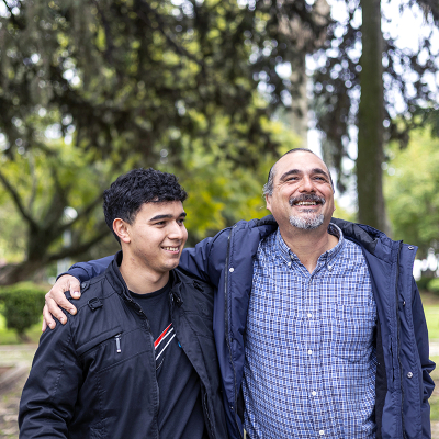 A father and son walking in a park