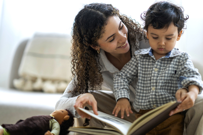 A woman and toddler reading a book